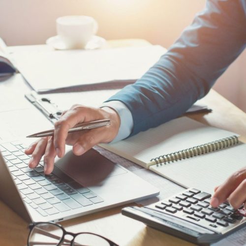 businessman working in office with using calculator and laptop. concept finance and accounting